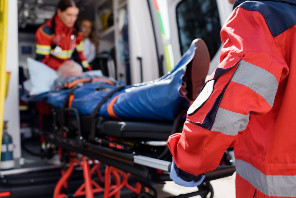 Transporting someone on a stretcher.